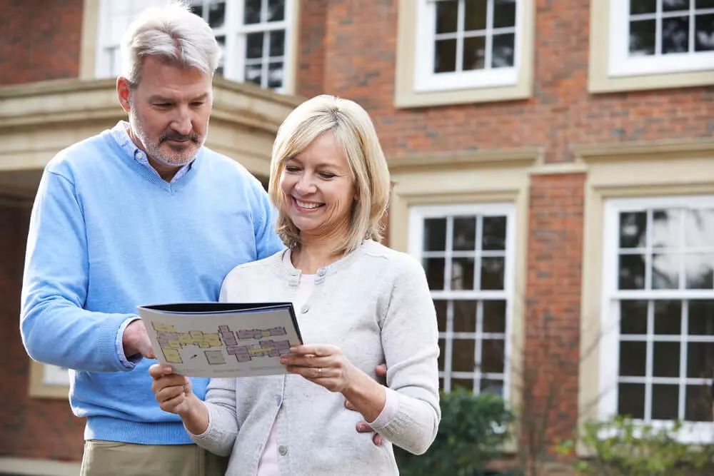 man and woman buying a house